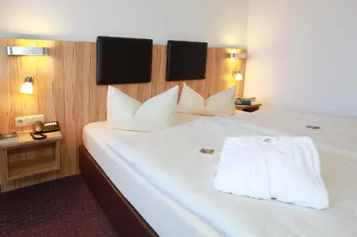 Ein Bett oder Betten in einem Zimmer der Unterkunft Hotel Promenade