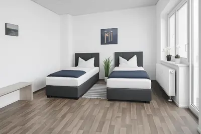 Ein Bett oder Betten in einem Zimmer der Unterkunft SUNNYHOME Monteurwohnungen und Apartments in Weiden