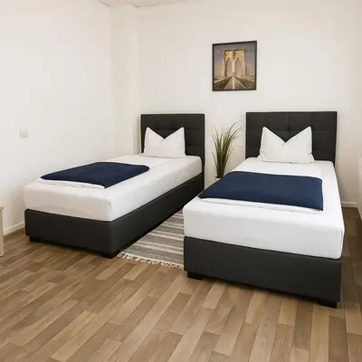 Ein Bett oder Betten in einem Zimmer der Unterkunft SUNNYHOME Monteurwohnungen und Apartments in Weiden