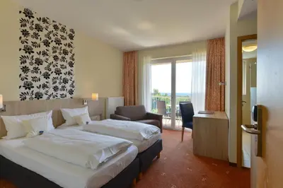 Ein Bett oder Betten in einem Zimmer der Unterkunft Schade's Wohlfühlhotel