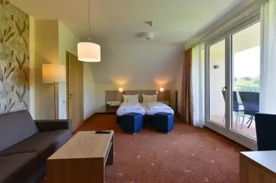 Ein Bett oder Betten in einem Zimmer der Unterkunft Schade's Wohlfühlhotel
