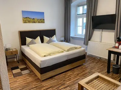 Ein Bett oder Betten in einem Zimmer der Unterkunft Gasthof Hotel Bräustübl und Haus Boutique