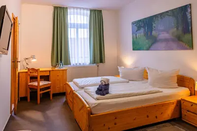Ein Bett oder Betten in einem Zimmer der Unterkunft Der Bayerische Hof