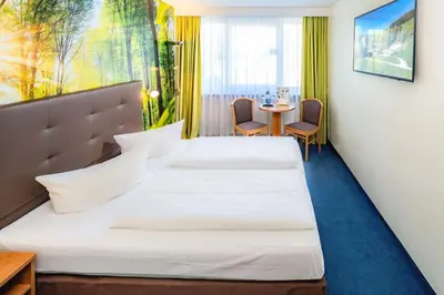 Ein Bett oder Betten in einem Zimmer der Unterkunft AHORN Hotel Am Fichtelberg