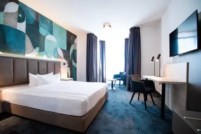 Ein Bett oder Betten in einem Zimmer der Unterkunft Taste Hotel Kulmbach