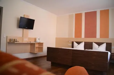 Ein Bett oder Betten in einem Zimmer der Unterkunft Hotel Königsteiner Hof