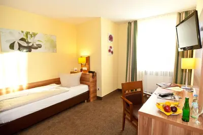 Ein Bett oder Betten in einem Zimmer der Unterkunft Hotel Strauss