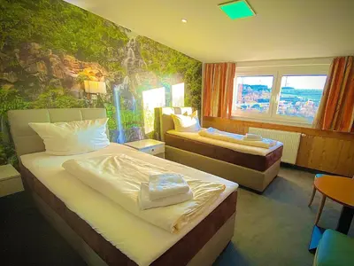 Ein Bett oder Betten in einem Zimmer der Unterkunft Meister BÄR HOTEL Frankenwald