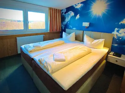 Ein Bett oder Betten in einem Zimmer der Unterkunft Meister BÄR HOTEL Frankenwald