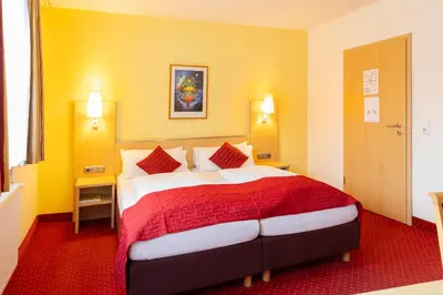 Ein Bett oder Betten in einem Zimmer der Unterkunft Hotel An der Eiche