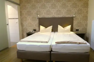 Ein Bett oder Betten in einem Zimmer der Unterkunft Hotel Munzert