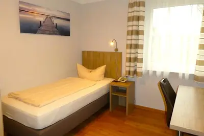 Ein Bett oder Betten in einem Zimmer der Unterkunft Hotel Munzert
