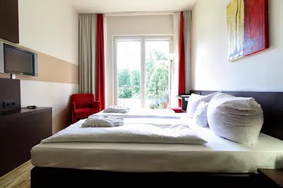 Ein Bett oder Betten in einem Zimmer der Unterkunft Santé Royale Hotel- & Gesundheitsresort Bad Brambach