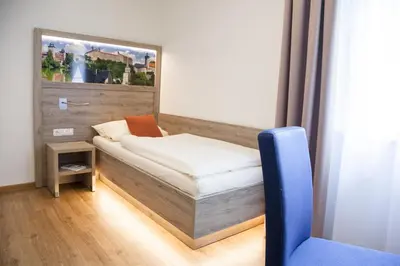 Ein Bett oder Betten in einem Zimmer der Unterkunft Hotel Ertl
