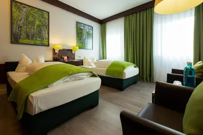 Ein Bett oder Betten in einem Zimmer der Unterkunft Hotel Goldener Hirsch