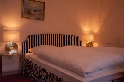 Ein Bett oder Betten in einem Zimmer der Unterkunft Hotel Garni Regina