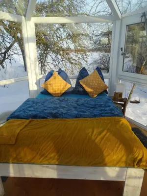 Ein Bett oder Betten in einem Zimmer der Unterkunft Glashaus Sternblick, Schlafen unterm Sternenhimmel