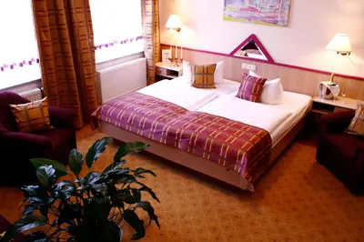 Ein Bett oder Betten in einem Zimmer der Unterkunft Parkhotel Helene