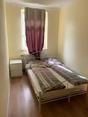 Ein Bett oder Betten in einem Zimmer der Unterkunft Ferienwohnung Goldener Drache