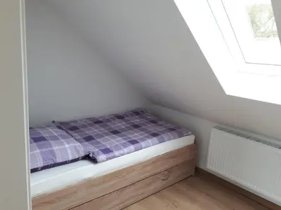 Ein Bett oder Betten in einem Zimmer der Unterkunft MaPaMaJo Home Base - Familienunterkunft mit Sauna