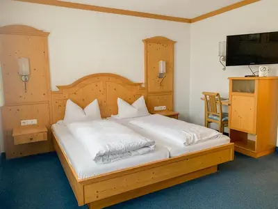 Ein Bett oder Betten in einem Zimmer der Unterkunft Landhotel Bauernschmitt