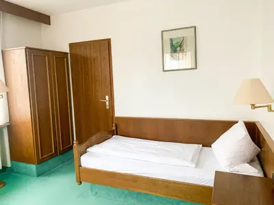 Ein Bett oder Betten in einem Zimmer der Unterkunft Landhotel Bauernschmitt