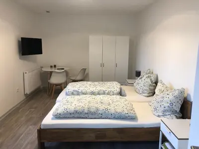 Ein Bett oder Betten in einem Zimmer der Unterkunft Pension Jägerschenke