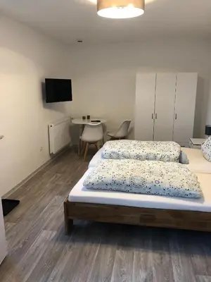Ein Bett oder Betten in einem Zimmer der Unterkunft Pension Jägerschenke