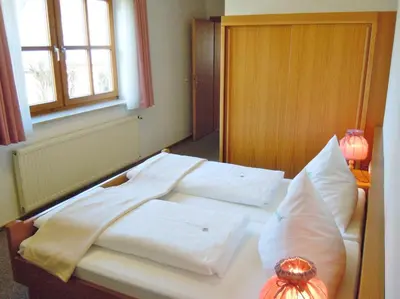 Ein Bett oder Betten in einem Zimmer der Unterkunft Hotel Lugerhof