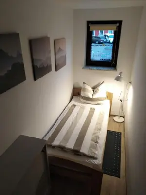 Ein Bett oder Betten in einem Zimmer der Unterkunft Ferienwohnung am Marktplatz