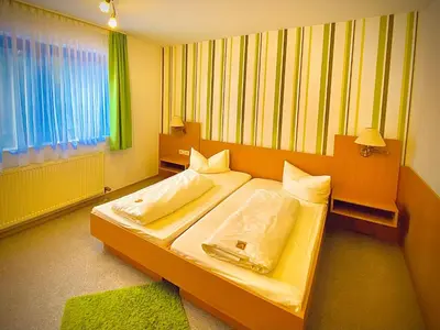 Ein Bett oder Betten in einem Zimmer der Unterkunft Fichtel-Hotel by Meister Bär