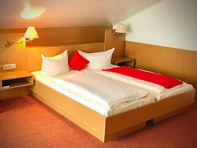 Ein Bett oder Betten in einem Zimmer der Unterkunft Fichtel-Hotel by Meister Bär