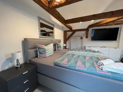Ein Bett oder Betten in einem Zimmer der Unterkunft Ferienwohnungen Yanev