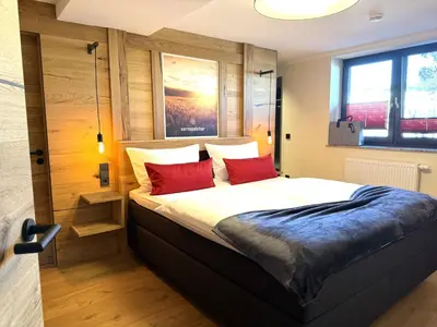 Ein Bett oder Betten in einem Zimmer der Unterkunft Ferienwohnung im Chaletstil Kornspeicher 70 qm Wellness Fitness Sauna Bergrödelhof