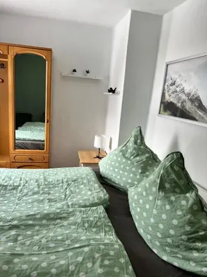 Ein Bett oder Betten in einem Zimmer der Unterkunft Gästehaus „Bei Emmi“