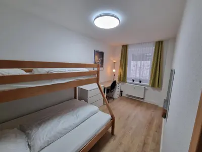 Ein Bett oder Betten in einem Zimmer der Unterkunft NEU FeWo Oberwiesenthal EG